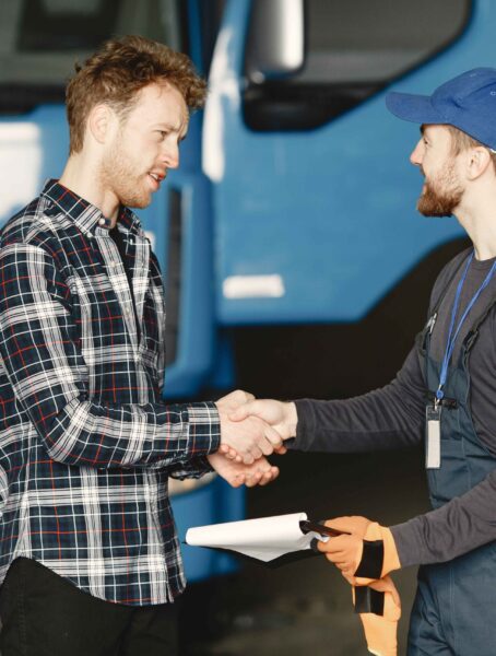 two-guys-talking-about-work-work-garage-near-truck-transfer-documents-with-goods (1)